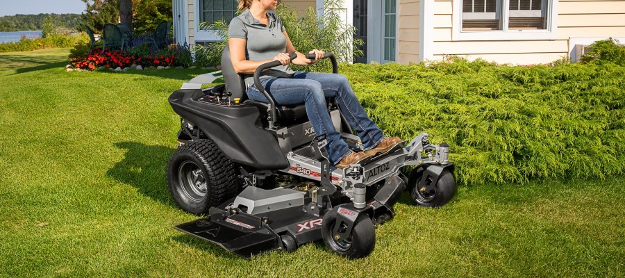 woman on zero turn lawn mower